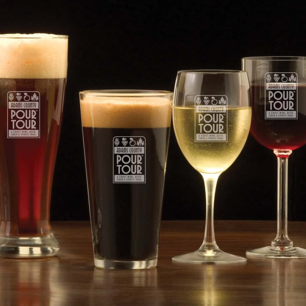 The Adams County Pour Tour beer glasses with beer and wine in them